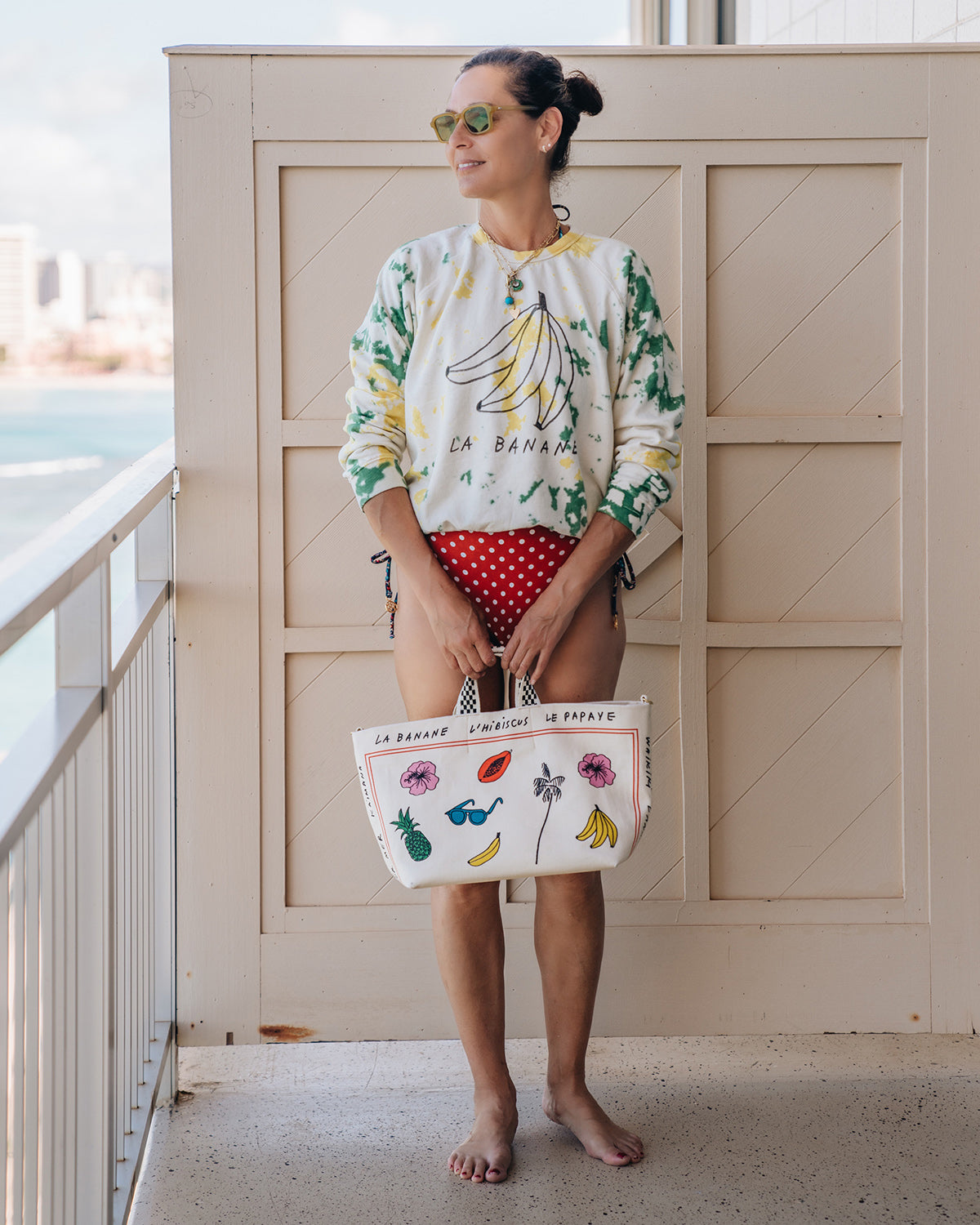 Marliene Wearing the La Banane Sweatshrit and Holding the CV x Le Catch Bateau Tote in Natural Paradis Print