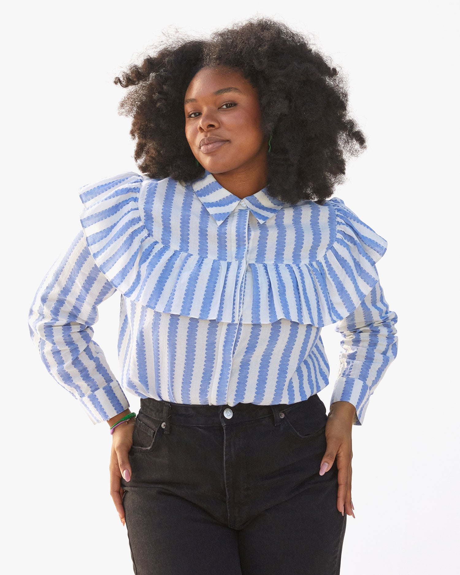 candace wearing the Blue and cream scallop stripe charlotte blouse all the way buttoned up and tucked in to black jeans