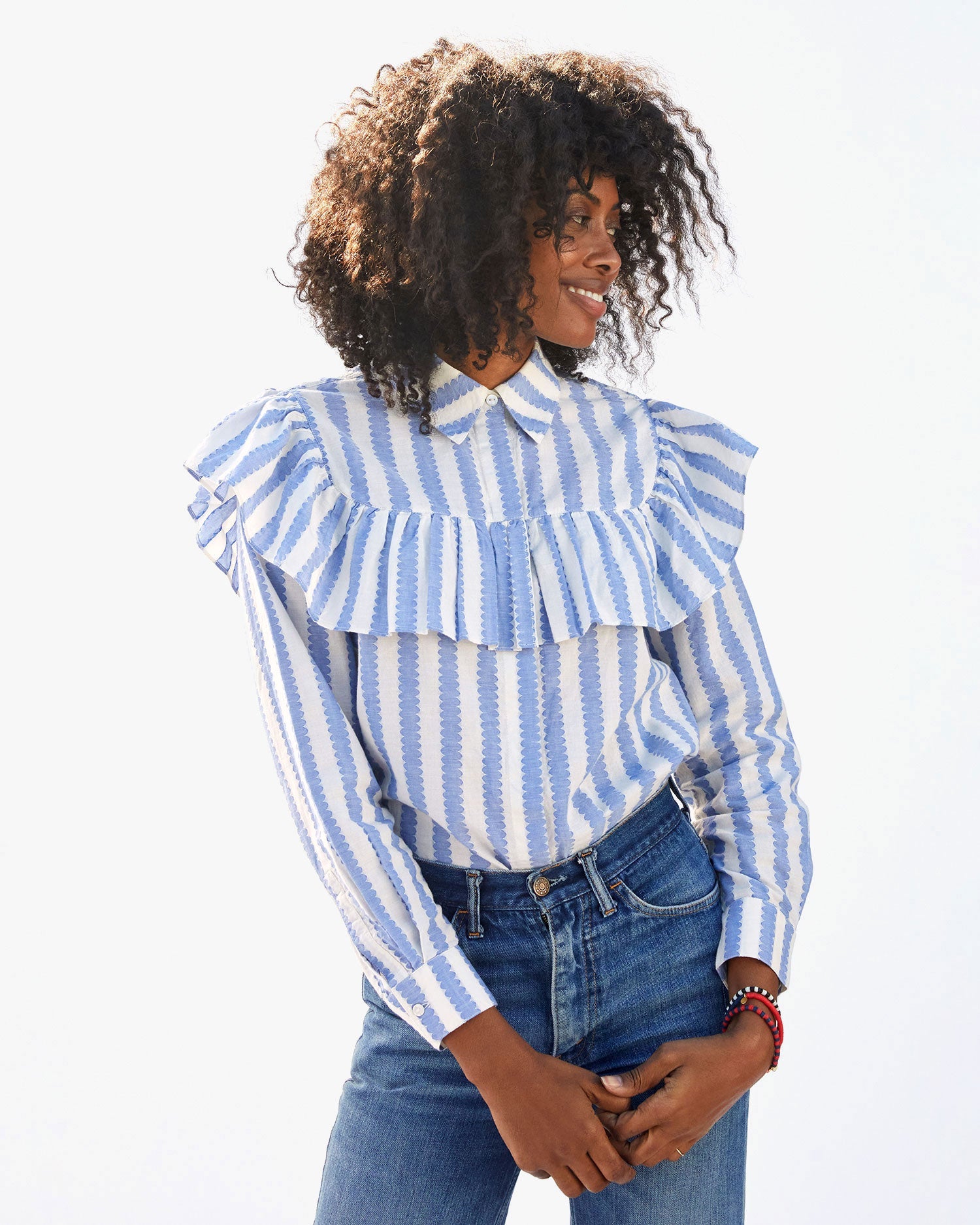 Mecca wearing the Blue & Cream Scallop Stripe Charlotte Blouse tucked in to jeans