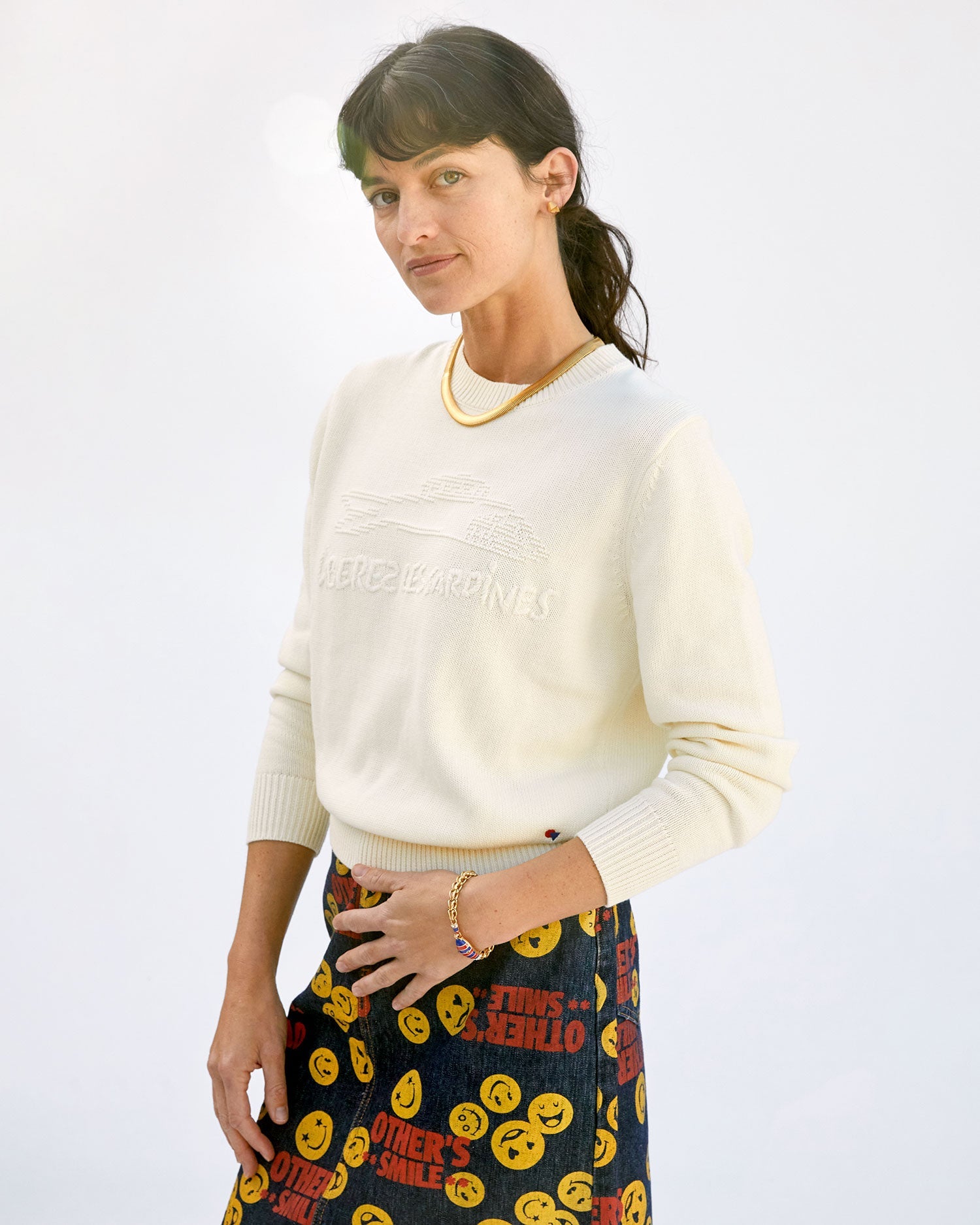 danica wearing the cream liberez les sardines Classic Sweater with a skirt with emojis on it 