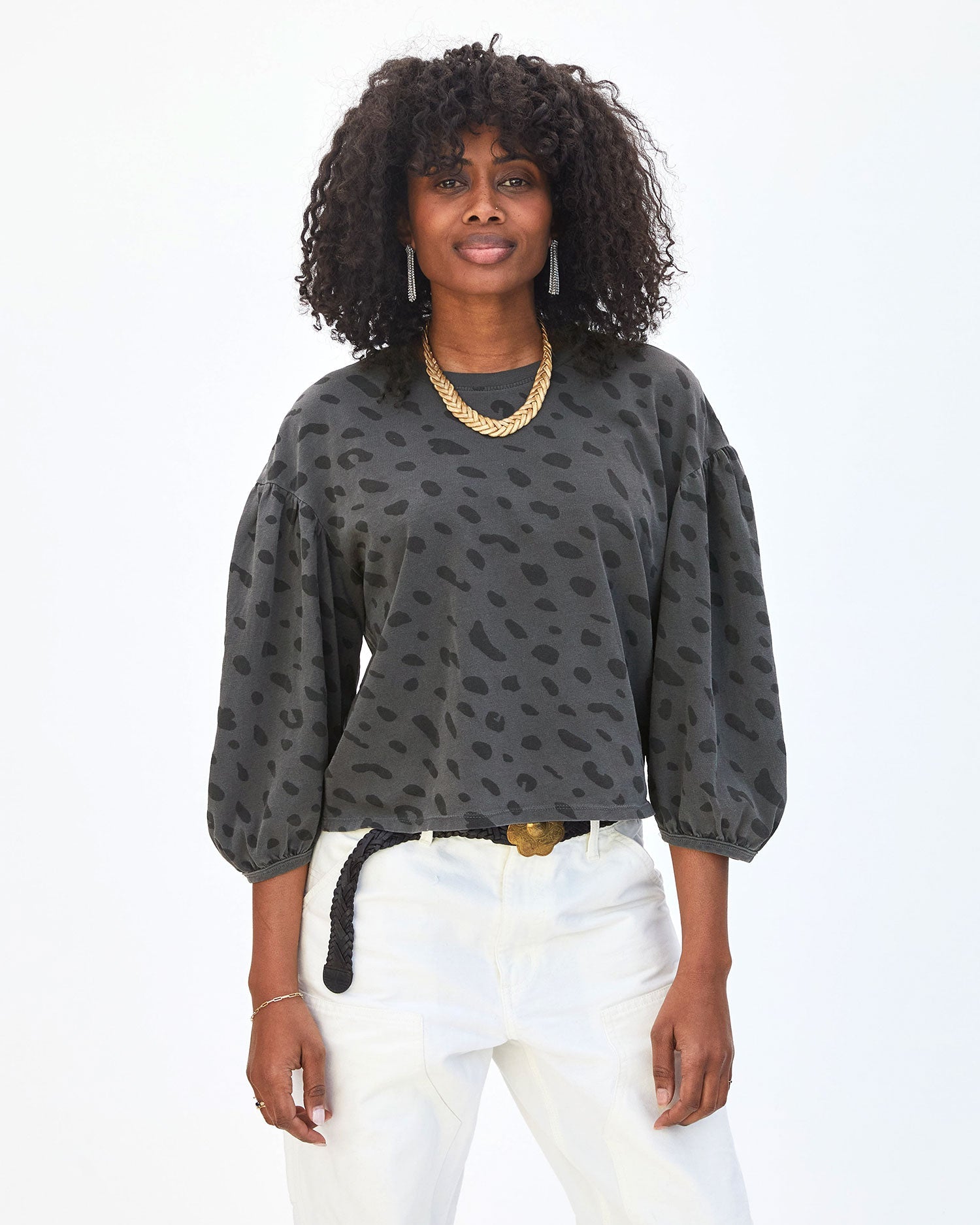 Mecca wearing the Faded Black Jag Drop Shoulder Tee and white pants