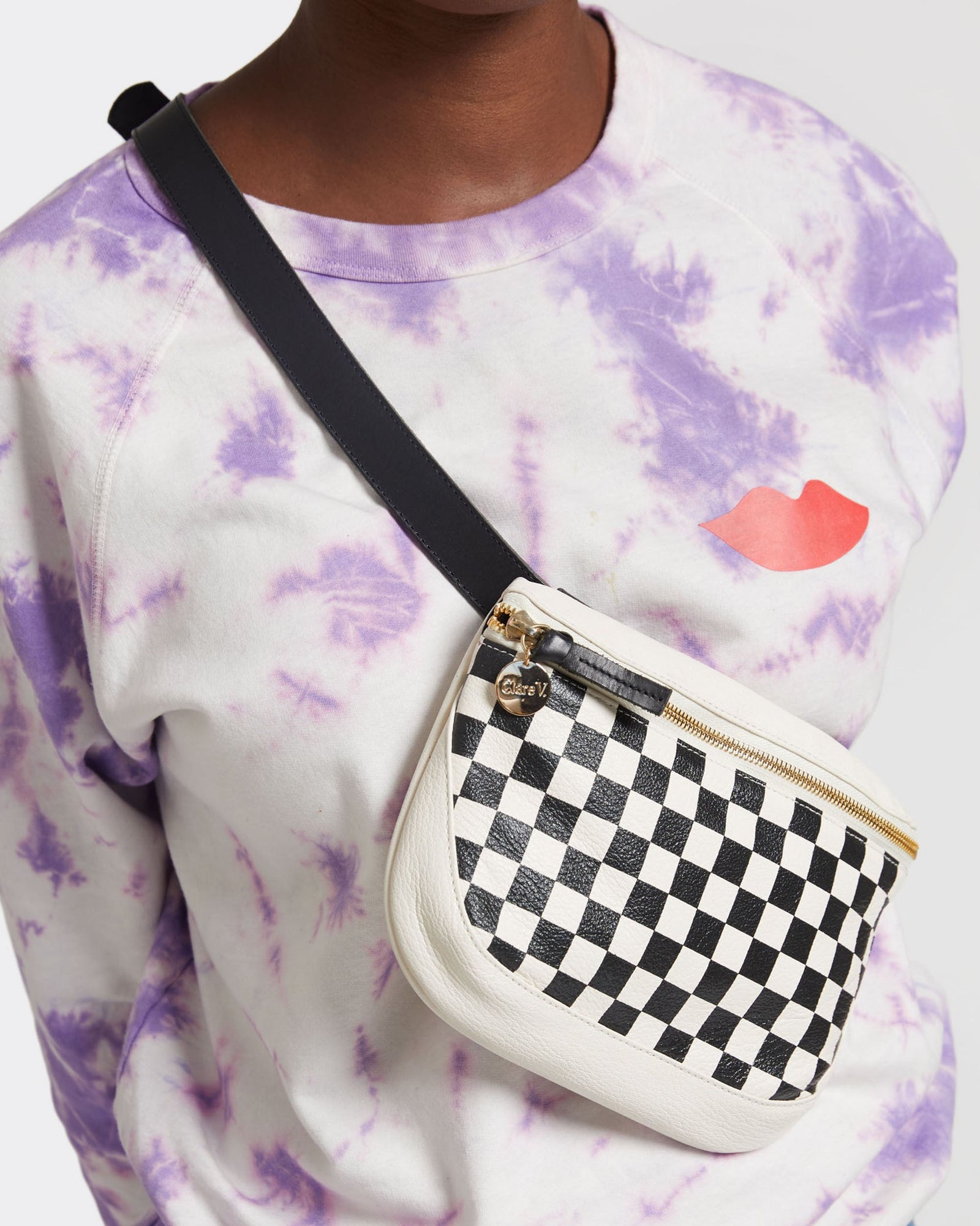 Up Close Shot of Kim Wearing the Cream with Black Checkers Fanny Pack Across her Chest