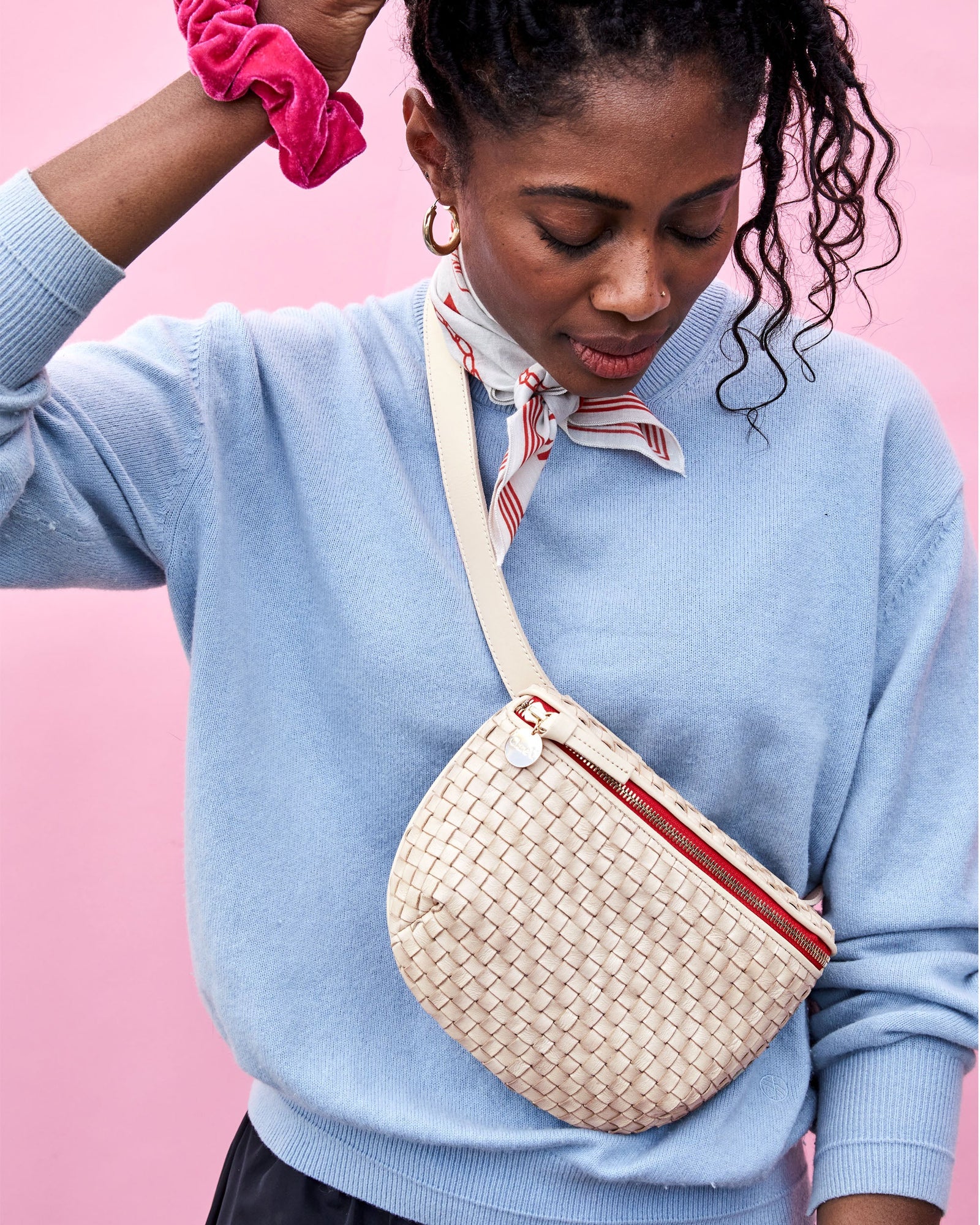 Mecca Wearing the Cream Woven Checker Fanny Pack and Touching her Hair