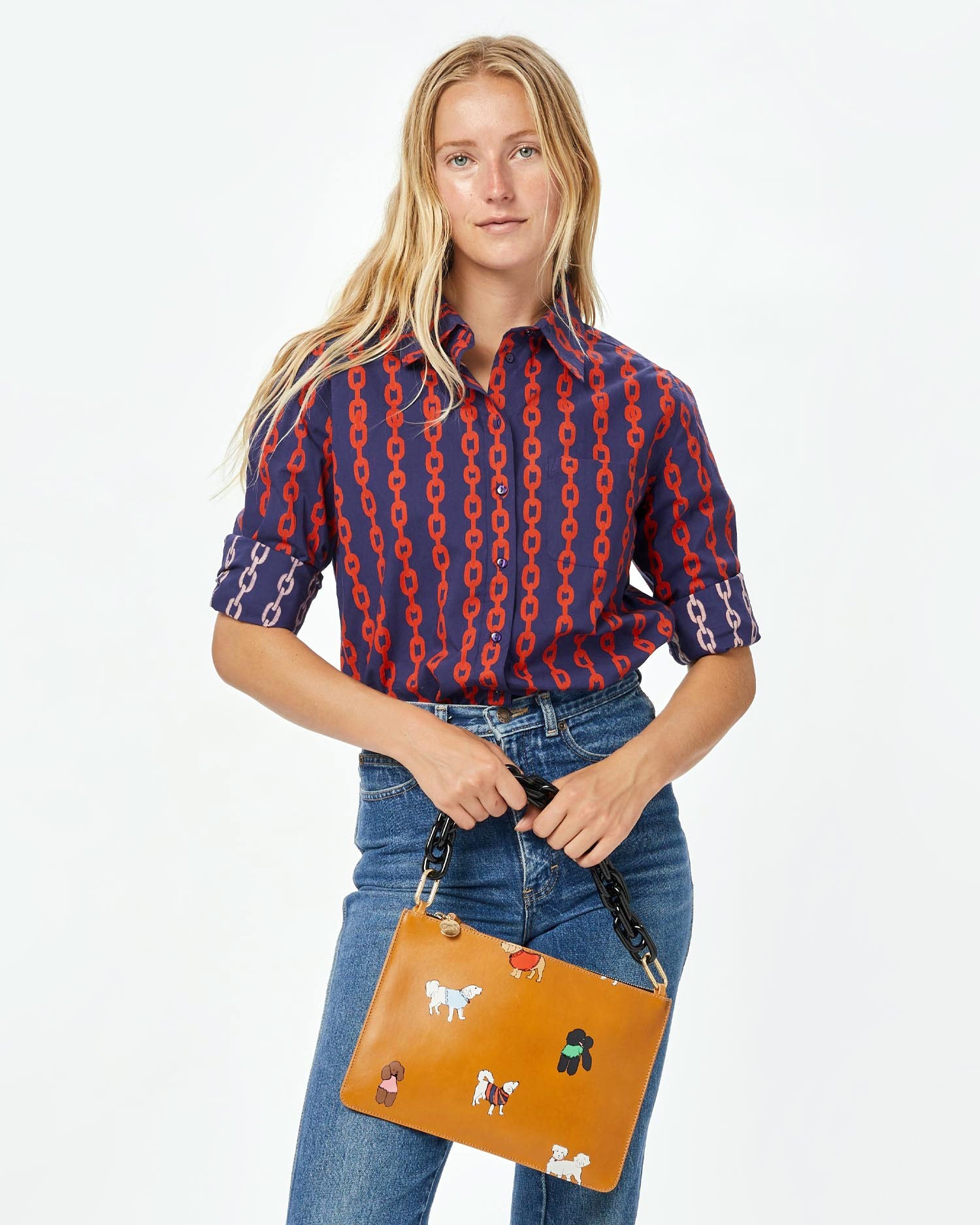 Natalie wearing the Navy and Poppy Chains Felix Blouse with jeans and the cuoio with paco and friends flat clutch with tabs with the black resin shortie strap attached