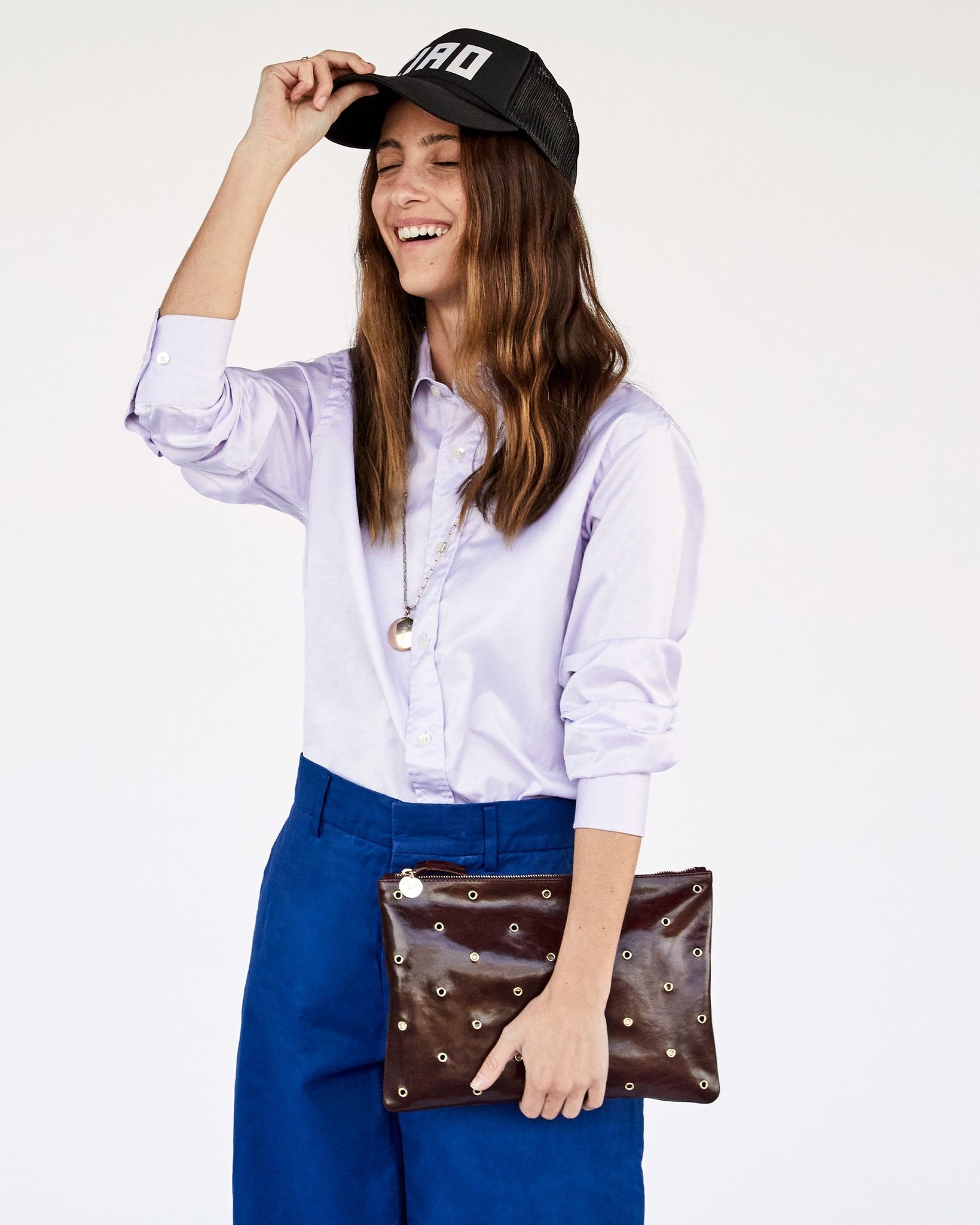 Frannie Carrying the Walnut w/ Grommets Flat Clutch with Tabs as a Clutch