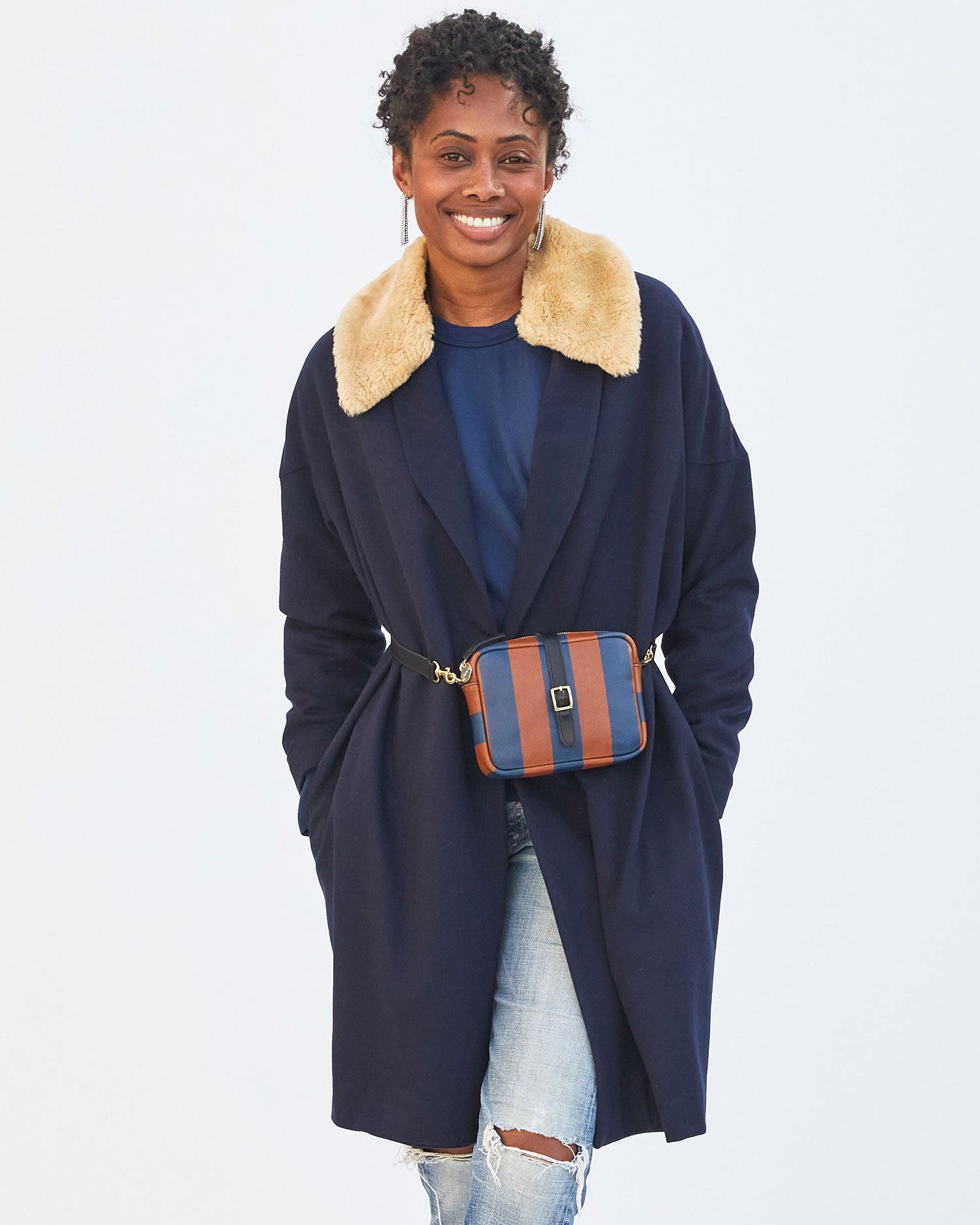 Mecca wearing the Cognac & Pacific Striped Gigi around her waist over a navy coat