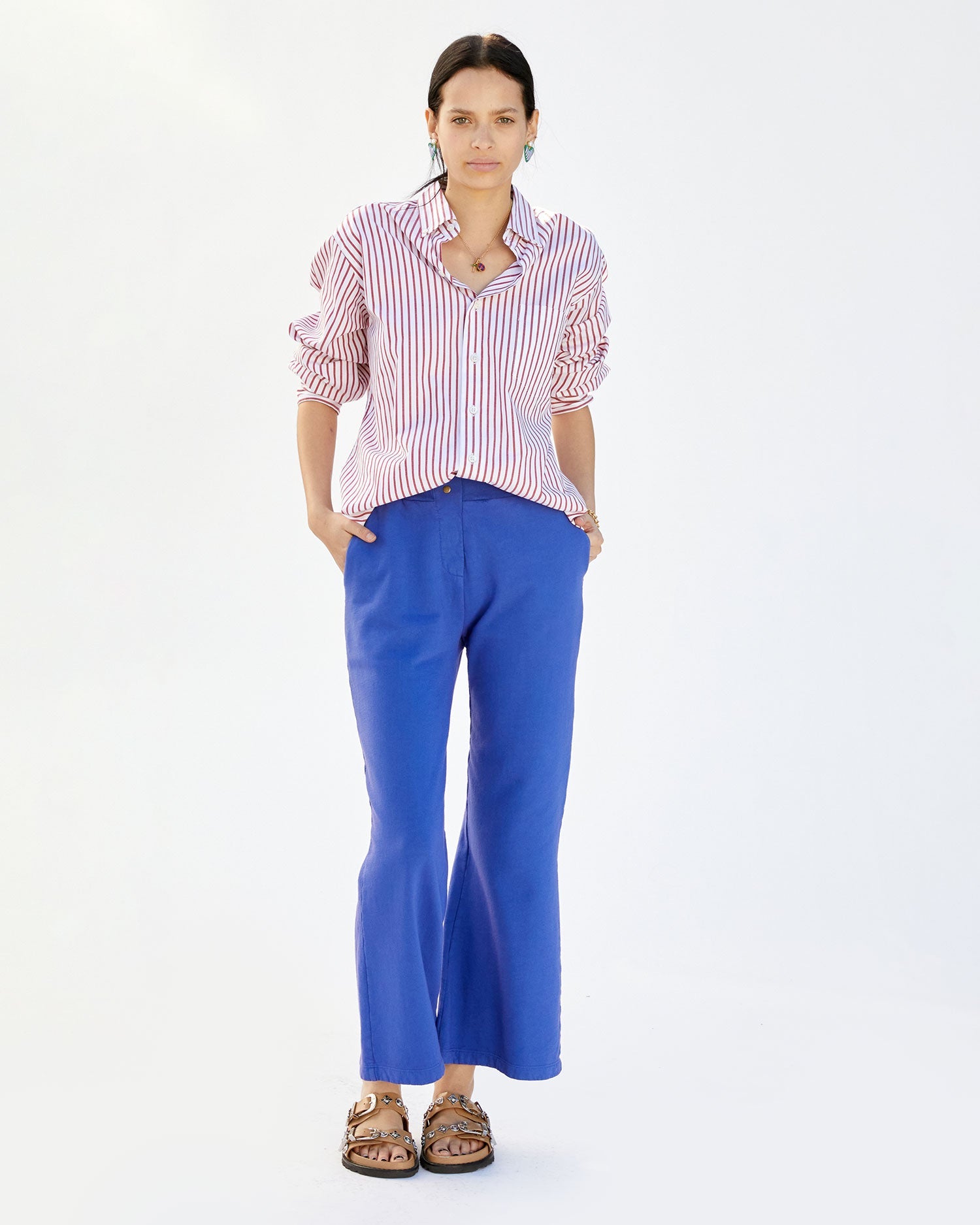 aurelia wearing the Cobalt Le Snap Pants with a button up shirt. her hands are in the pant's pockets and she's wearing sandals