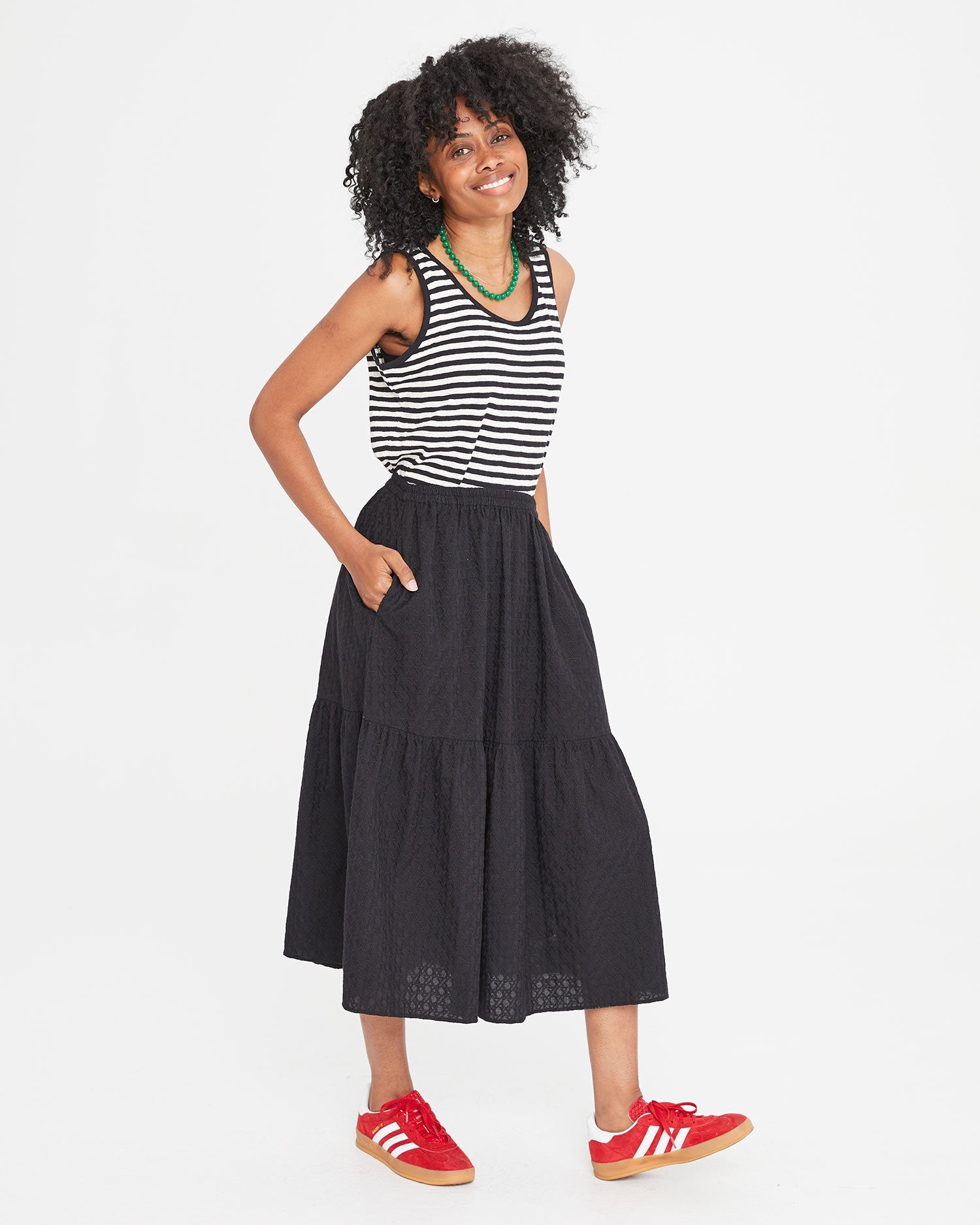 Mecca with her hands in the pockets of the Black Eyelet Rattan Manon Skirt