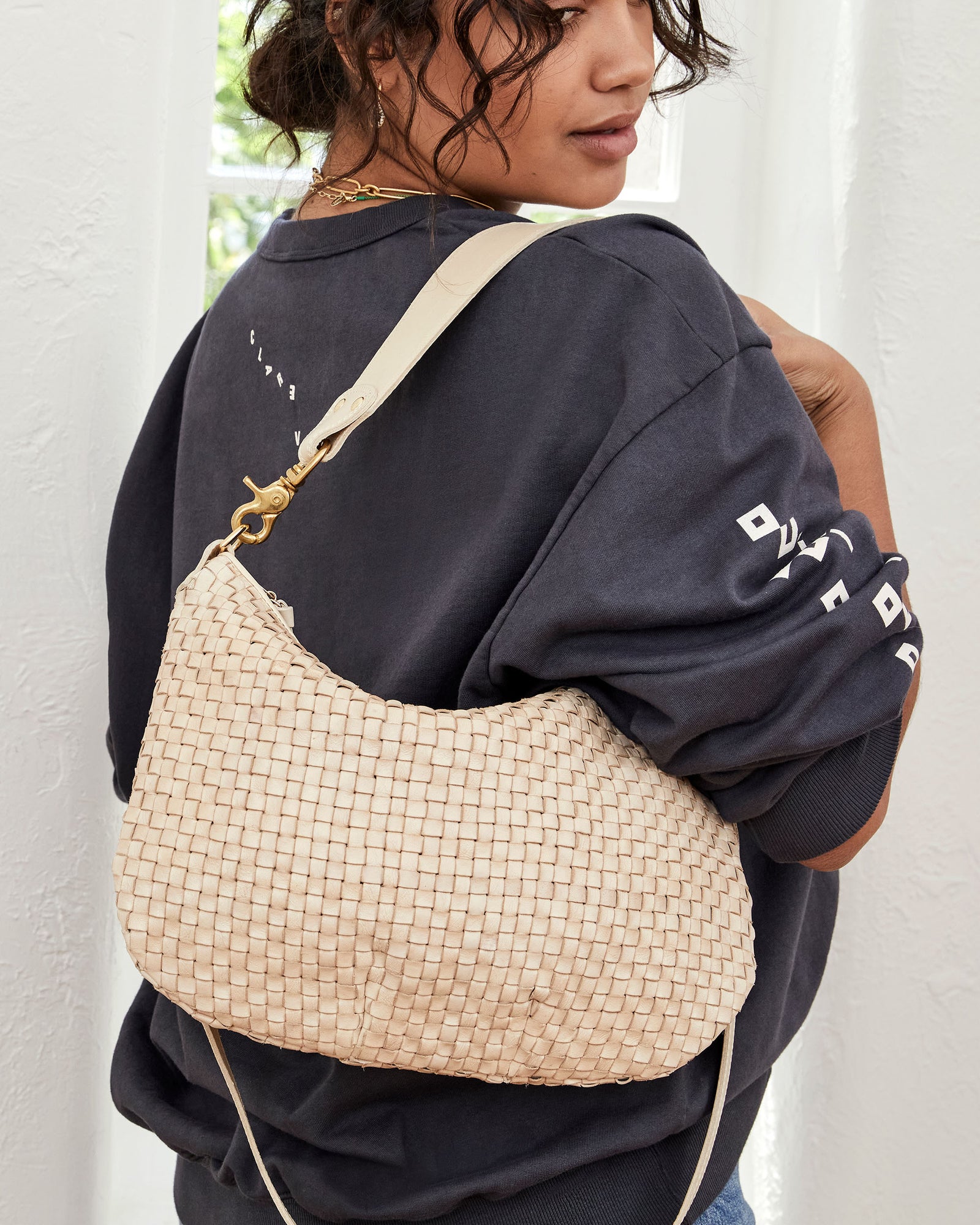 Claudia Carrying the Cream Woven Checker Moyen Messenger with the Shoulder Strap