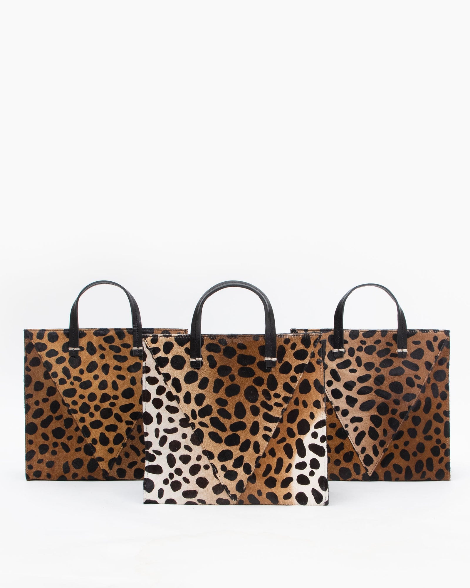 Three Leopard Petit Simple Totes Sitting Next to Each Other