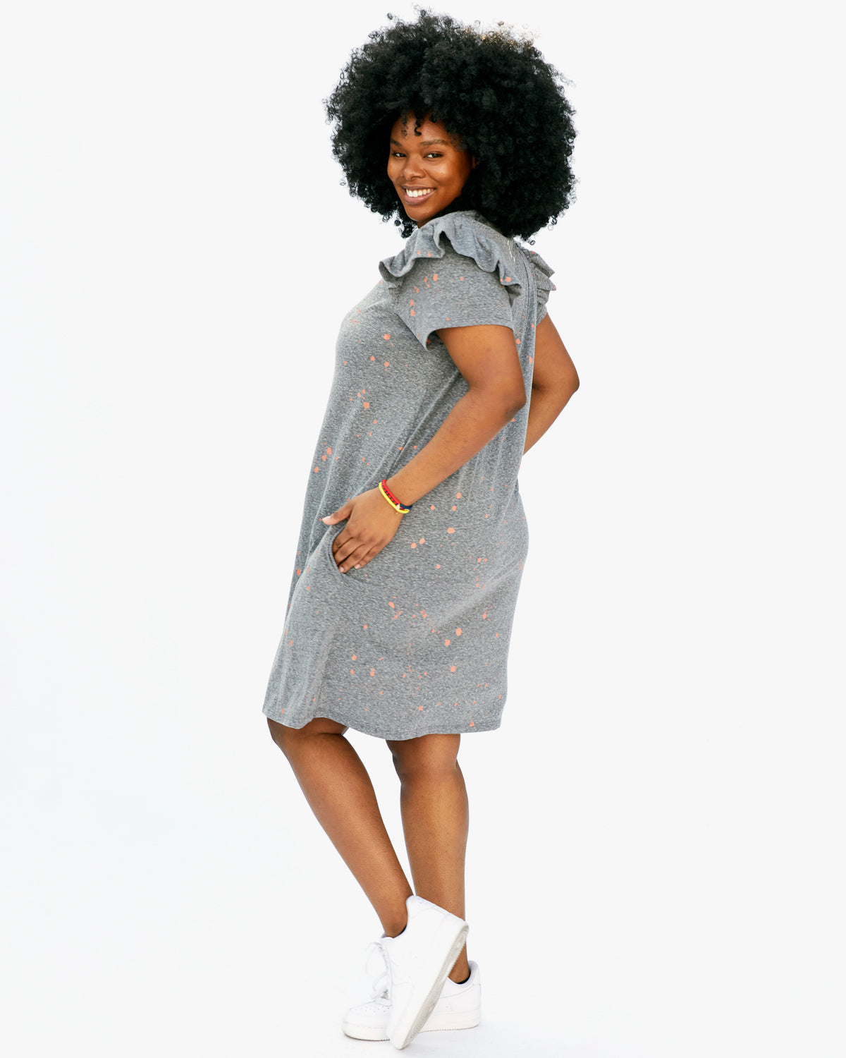 Candace with her Hands in the Pockets of the Grey w/ Salmon Splash Ruffle Dress
