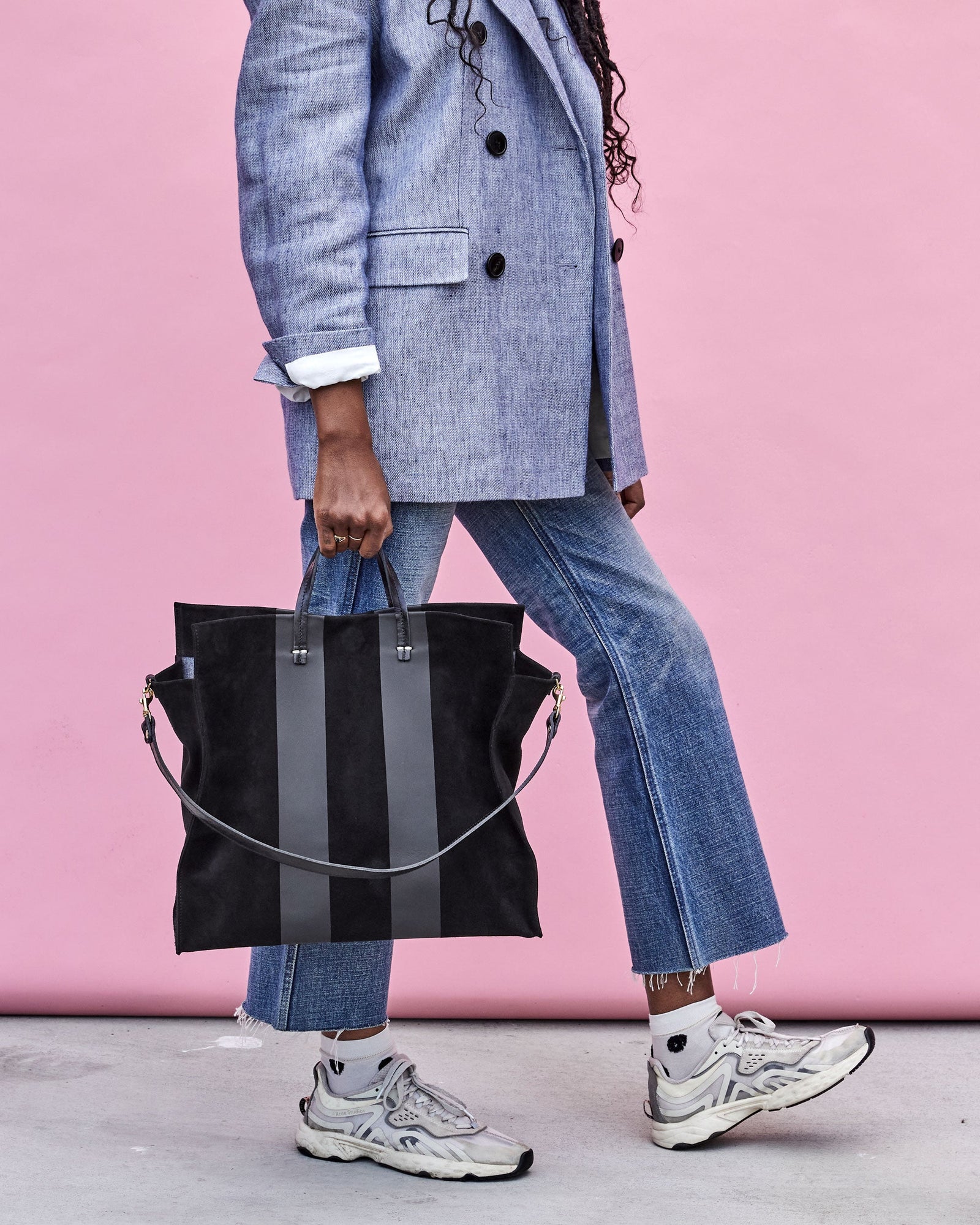 Mecca Holding the  Black Suede with Matte Black Racing Stripes Simple Tote By the Top Handle
