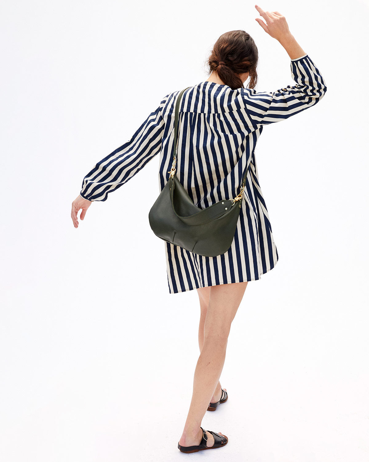 Danica Spinning Around Wearing the Navy & Cream Stripe St. Martin Dress and the Loden Moyen Messengery