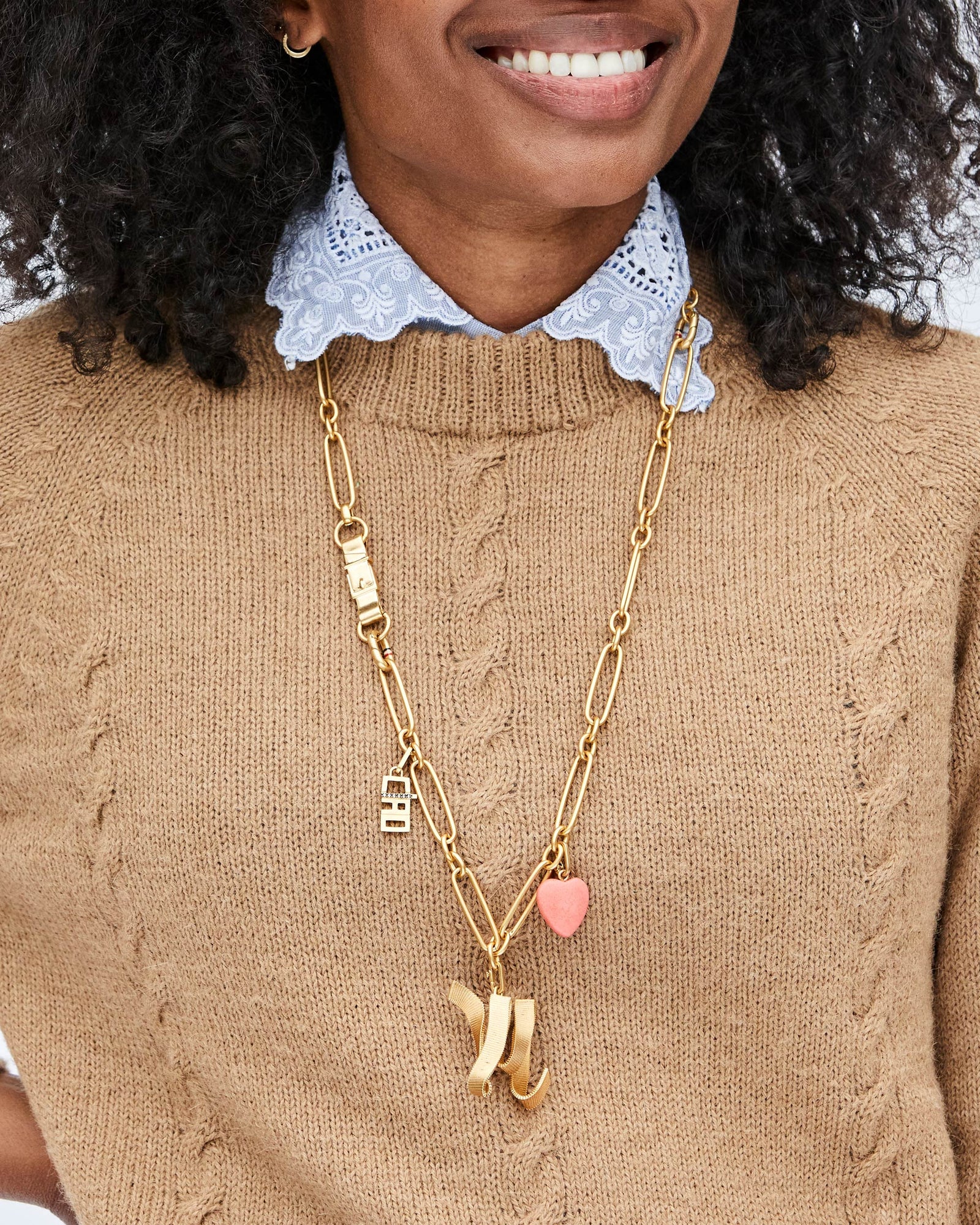 Mecca Wearing the Coral Stone Heart Charm with Other Charms on the Convertible Chain Charm Necklace